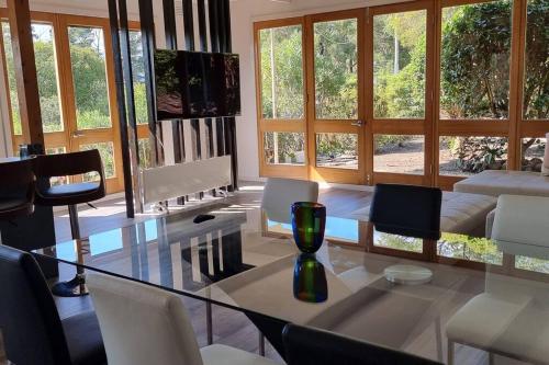a living room with a glass table and chairs at Liz Garden country house in Woori Yallock