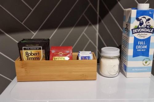 a shelf with a wooden box with different items on it at Liz Garden country house in Woori Yallock