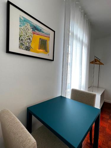 a blue table in a room with two chairs at VILA ALEGRIA by brugrani in Funchal