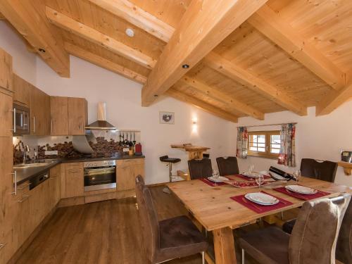 a kitchen and dining room with a wooden table at Apartment in Kaprun near the ski area in Kaprun