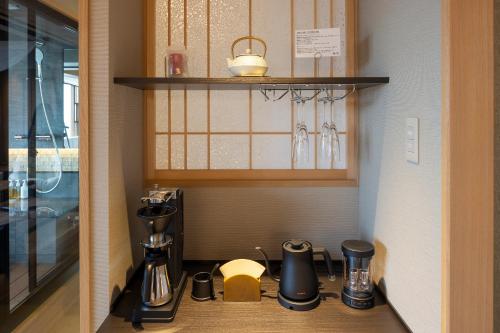a kitchen with a coffee maker on a counter at Biwako Ryokusuitei in Otsu
