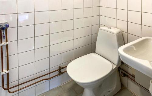 a bathroom with a white toilet and a sink at Lovely Home In Svenljunga With Wifi in Svenljunga