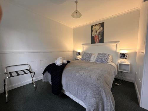 a bed in a bedroom with a white bedspread at Smugglers Rest Apartments Dover in Dover