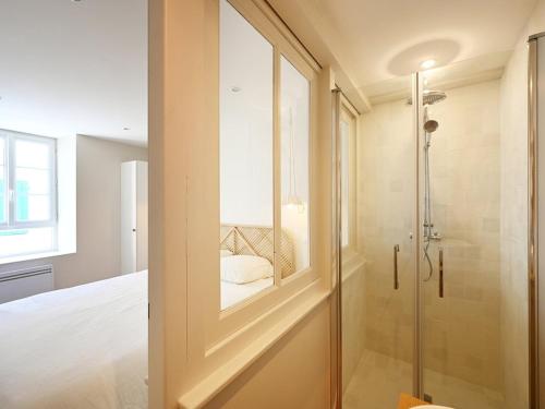 a glass door leading to a shower in a bedroom at Maison Rénovée avec Jacuzzi et Cuisine d'Été au Centre du Village - FR-1-434-97 in La Couarde-sur-Mer