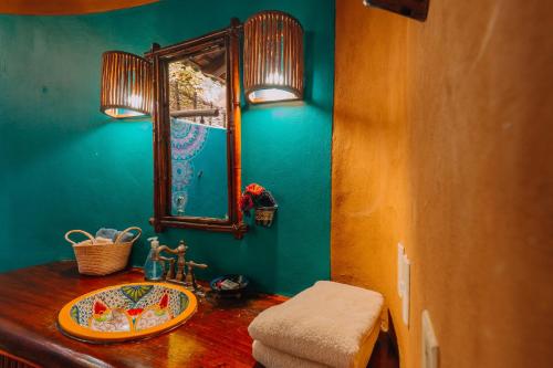 a bathroom with a sink and a mirror at Tres Mujeres Hotel in Troncones
