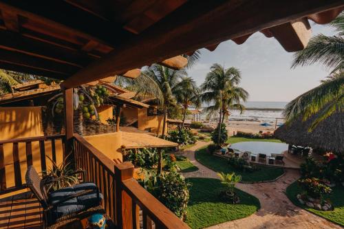 an outdoor balcony of a resort with a view of the beach at Tres Mujeres Hotel in Troncones