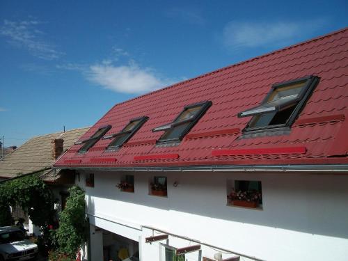 a red roof on top of a building at Casa Sara in Săcele