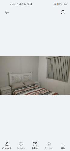 two empty beds in a room with avertisement for at Lirio House Near the industrial parks Highway 57 in Querétaro