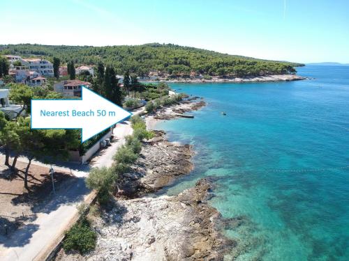 an aerial view of a beach with a sign that reads nearest beach at Apartments Villa La Riva - Seafront accommodation in Sutivan
