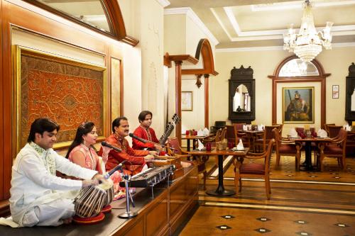 a group of people sitting in a room playing instruments at Eros Hotel New Delhi, Nehru Place in New Delhi