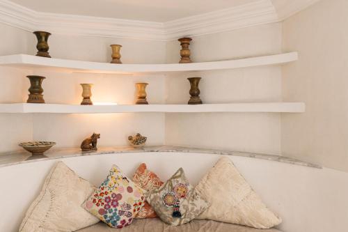 a bunch of pillows sitting on a shelf at At Niman conceptual Home chiangmai in Chiang Mai