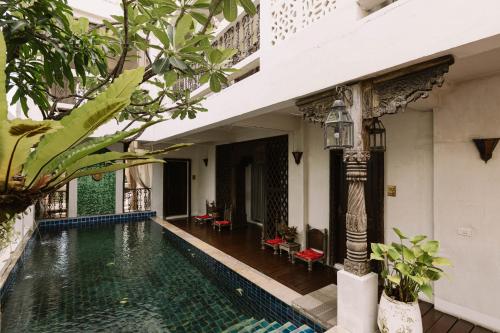 a swimming pool in the courtyard of a building at At Niman in Chiang Mai