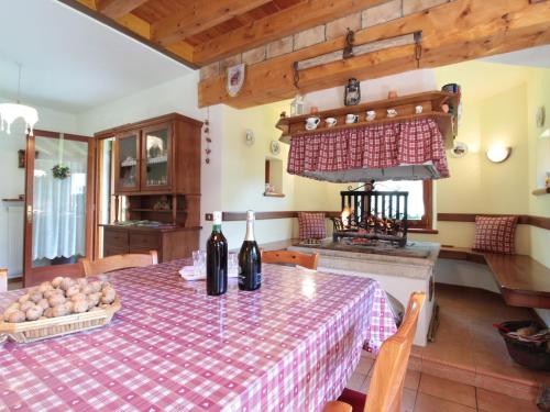 a kitchen with a table with wine bottles on it at Holiday Home in Cison with Mountain Views in Cison di Valmarino