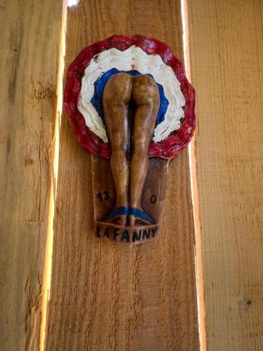 a wooden figurine of a leg on a wooden table at Cabanon bucolique face au Luberon in Lourmarin