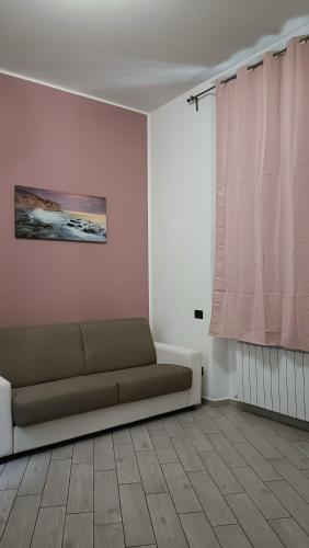 a living room with a couch and a window at Il filo di Claudia in Savona