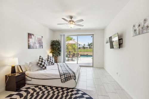a bedroom with a bed and a ceiling fan at Desert Escape, Stunning View, Pool, BBQ, Firepit, Gated, Walk2 Coachella Music Festival in Indio