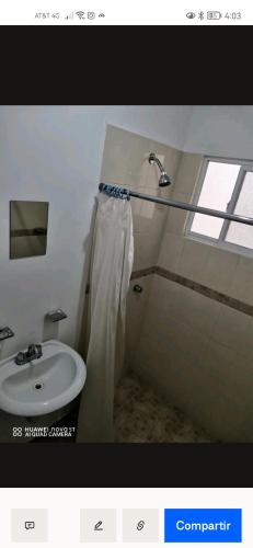 a bathroom with a sink and a shower curtain at Lirio House Near the industrial parks Highway 57 in Querétaro