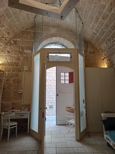 a room with an open door in a building at Donna Isabella in Trani