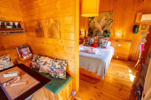 a bedroom with a bed in a wooden cabin at Le Bassin du Tertre in Fronsac