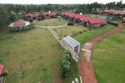 an aerial view of a group of houses with red roofs at vihangama Home Stay in Chāmundi