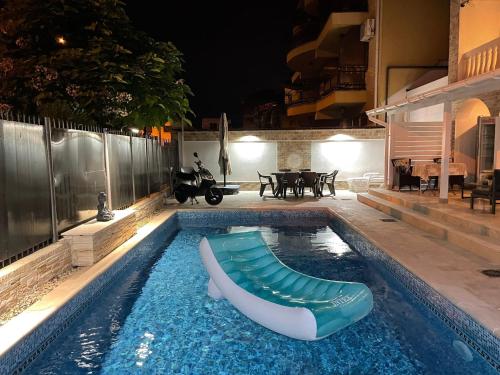a swimming pool at night with a boat in it at Villa ANA in Eforie Sud