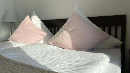 a bed with pillows on top of it at Villa Rosalie Sassnitz in Sassnitz