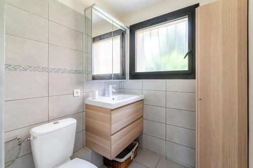une salle de bain avec toilettes, lavabo et fenêtre dans l'établissement La Viguerie par Dodo-a-Cassis, à Cassis