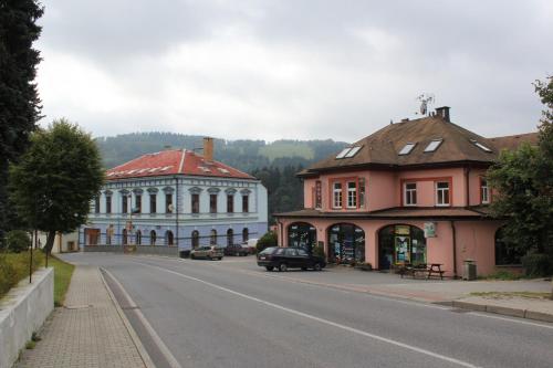 a street in a town with buildings on the side of the road at Penzion Breuer in Jablonec nad Jizerou