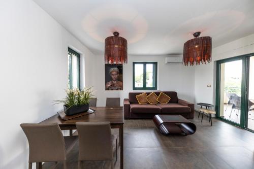 a living room with a couch and a table at Mama House Villa in Novalja