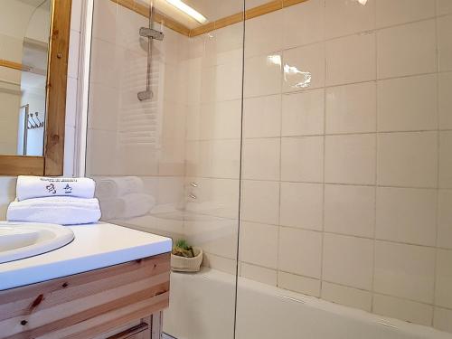 a white bathroom with a shower and a sink at Appartement Les Menuires, 3 pièces, 6 personnes - FR-1-344-798 in Levassaix
