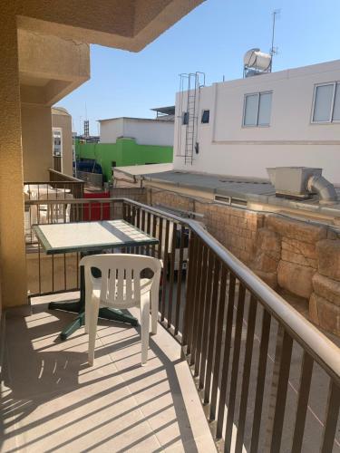 a patio with a table and a chair on a balcony at Flora Maria Hotel in Ayia Napa