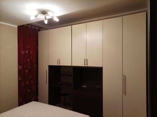 a bedroom with white cabinets and a bed at Il nido in Alba