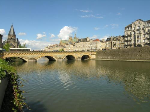 a bridge over a river in a city with buildings at Mercure Metz Centre in Metz