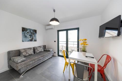 a living room with a couch and a table at Mama House Villa in Novalja
