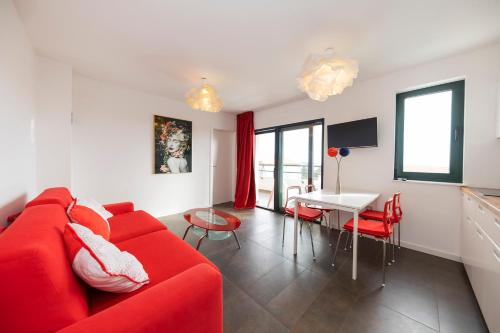 a living room with a red couch and a table at Mama House Villa in Novalja