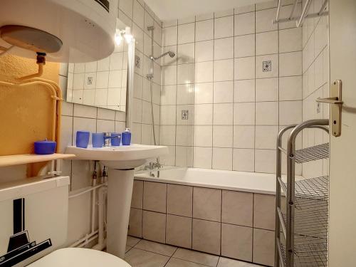 une salle de bain avec un lavabo et une baignoire dans l'établissement Studio Cabine Confort · Proche Pistes · Balcon Sud - FR-1-344-903, aux Menuires