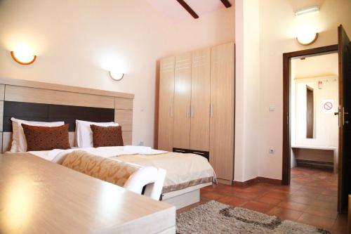 a bedroom with two beds and a table in it at S Club Resort Hotel Aqua Park and Spa in Belgrade