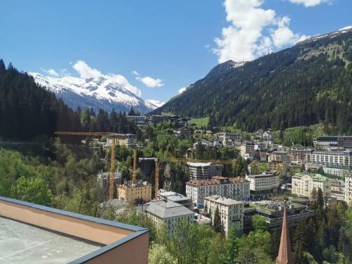 a view of a city with mountains in the background at The View - Design Panorama Lodge DAS SCHILLER in Bad Gastein