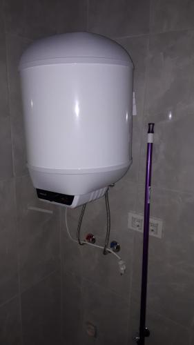a white toilet in a bathroom with a tank at Geyikli suit apart3 in Geyikli