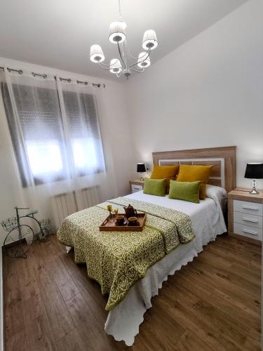a bedroom with a large bed with a tray on it at Descanso Natural Bueu in Bueu