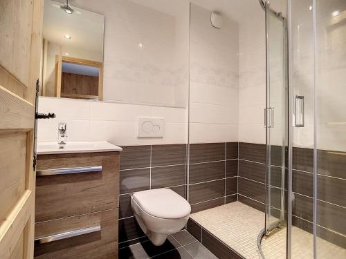 a bathroom with a toilet and a glass shower at Studio rénové confortable, accès piste, balcon sud - FR-1-344-953 in Les Menuires