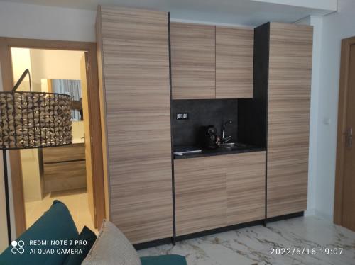 a large wooden cabinet in a living room at Suites 5* Lahcene in Alicante