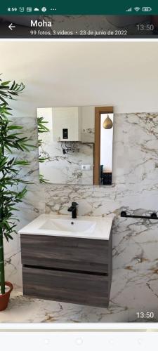 a bathroom with a sink and a mirror at Suites 5* Lahcene in Alicante