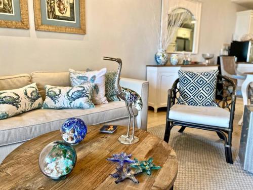 a living room with a couch and a table at Stylish Lux Beach Condo Aquamarina Cap Cana in Punta Cana