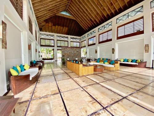 a large room with couches and tables in a building at Stylish Lux Beach Condo Aquamarina Cap Cana in Punta Cana