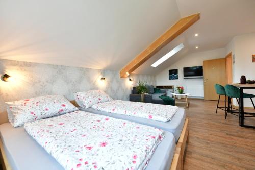a bedroom with two beds and a living room at House Bela vido in Drežnik Grad