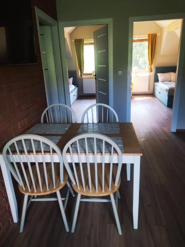 two chairs and a table in a room at Gościnna Chata in Jaworki