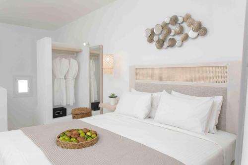 a bedroom with a bed with a basket of apples on it at Cosmos Hotel in Plaka