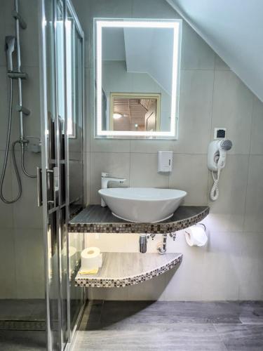 a bathroom with a sink and a mirror at Willa Admirał Solina in Solina