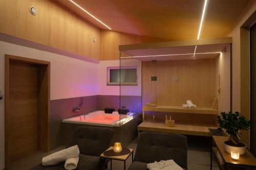 戈紹的住宿－Bergzeit Gosau，一间位于客房角落的带浴缸的客厅